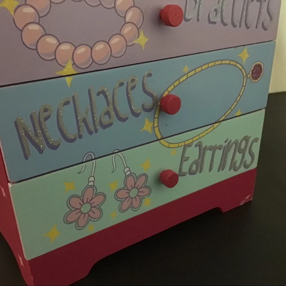 Children’s wood four drawer jewelry chest.